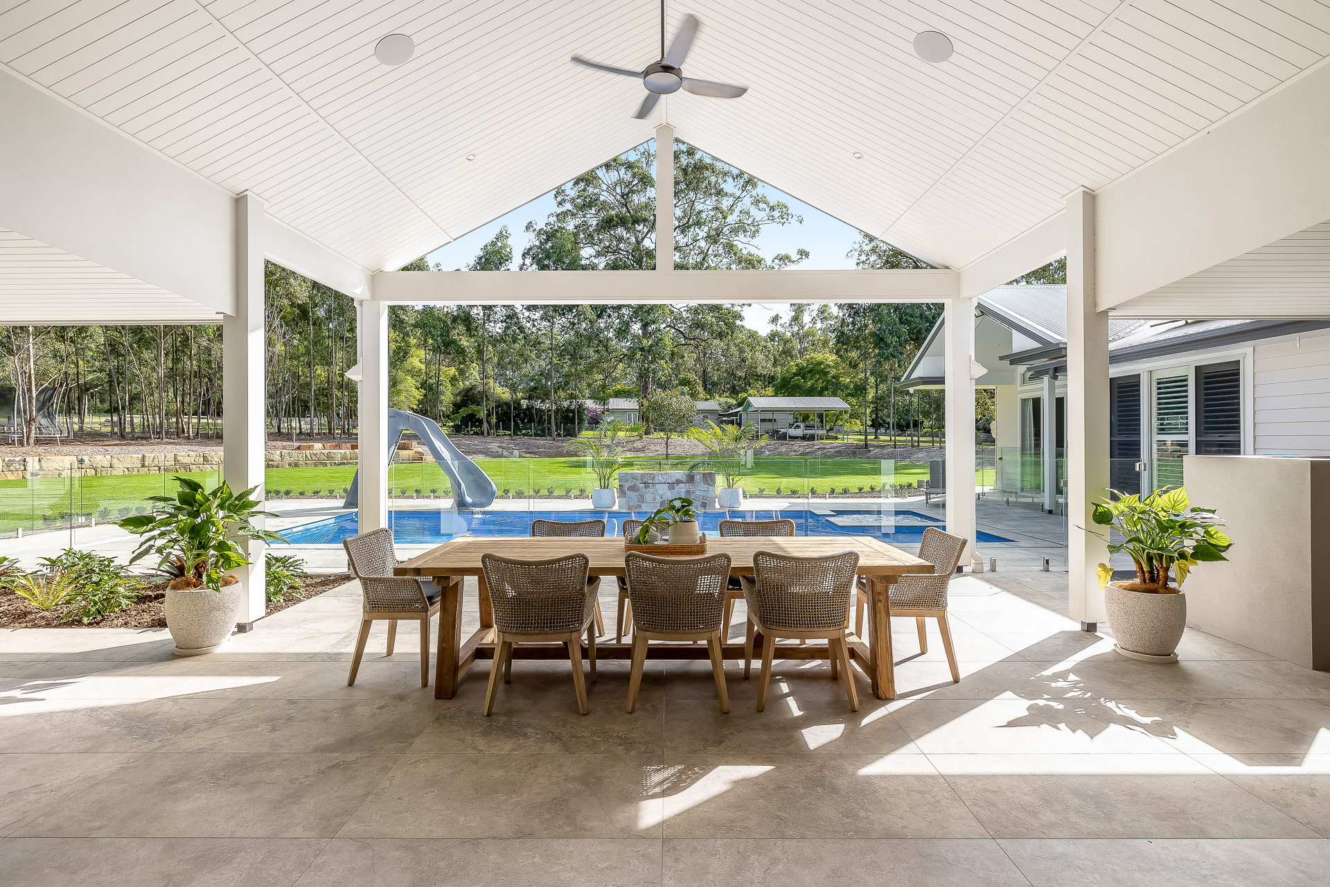 A kitchen with a large island and stools in it — Windamere Homes in Highfields, QLD
